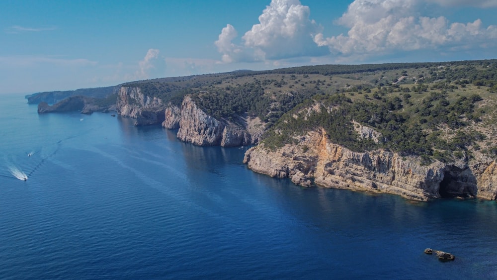 an aerial view of a boat in a body of water