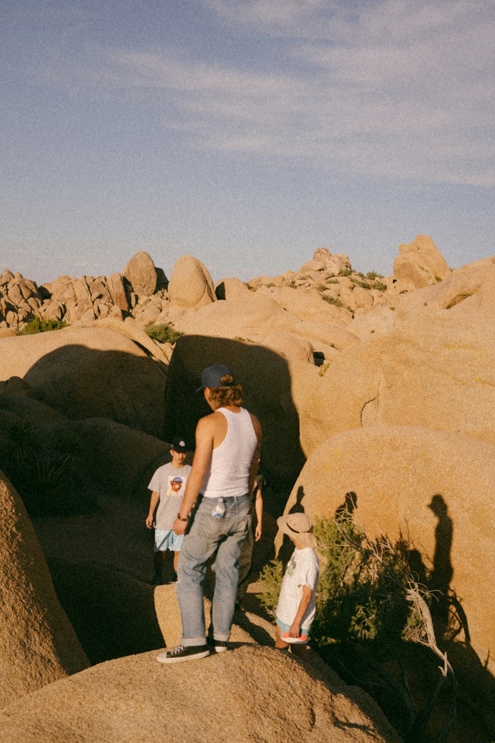 a woman and two children standing on a rock formation