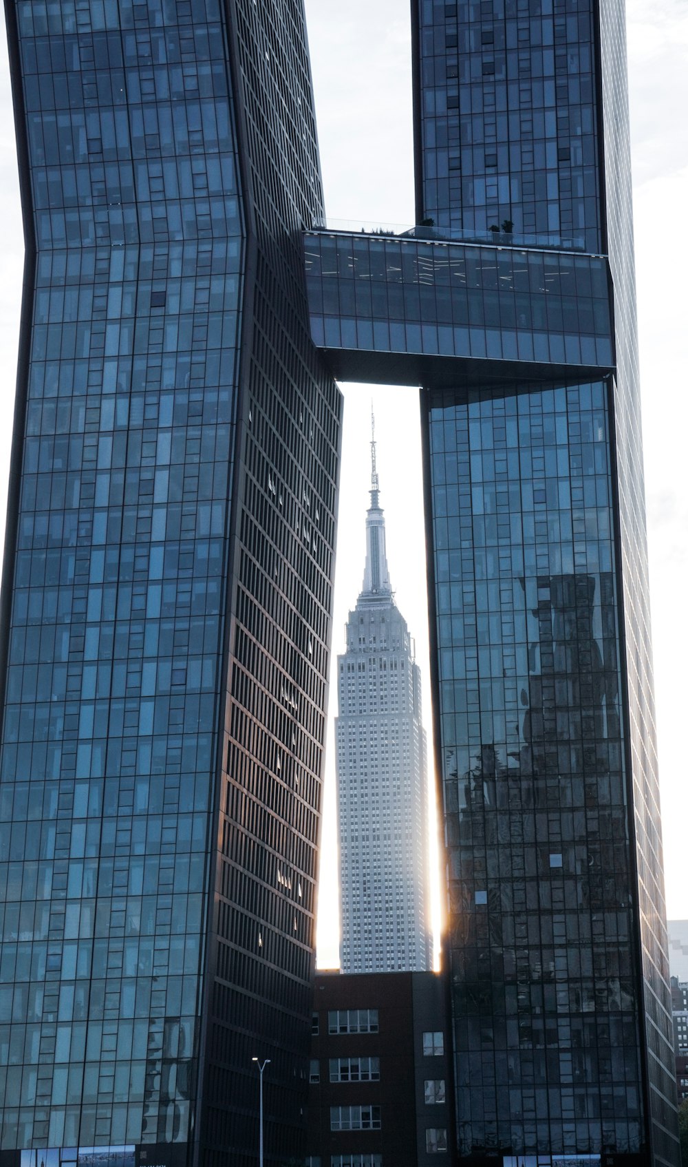 a tall building with a spire in the middle of a city