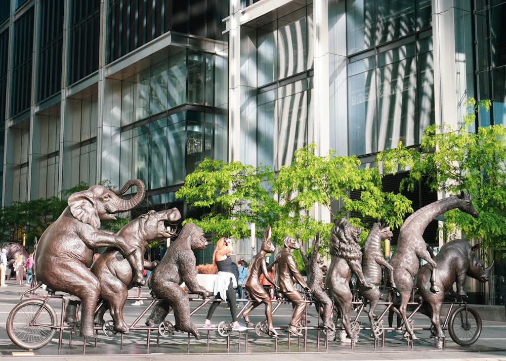 a group of elephants riding on top of a bike