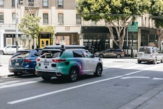 a couple of cars that are sitting in the street
