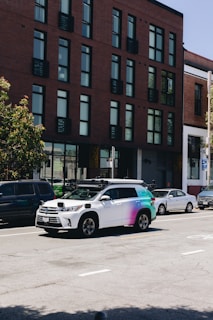 An empty road with an autonomous vehicle parked beside it.