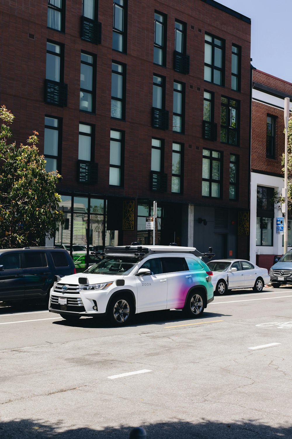 a multicolored car parked on the side of the road