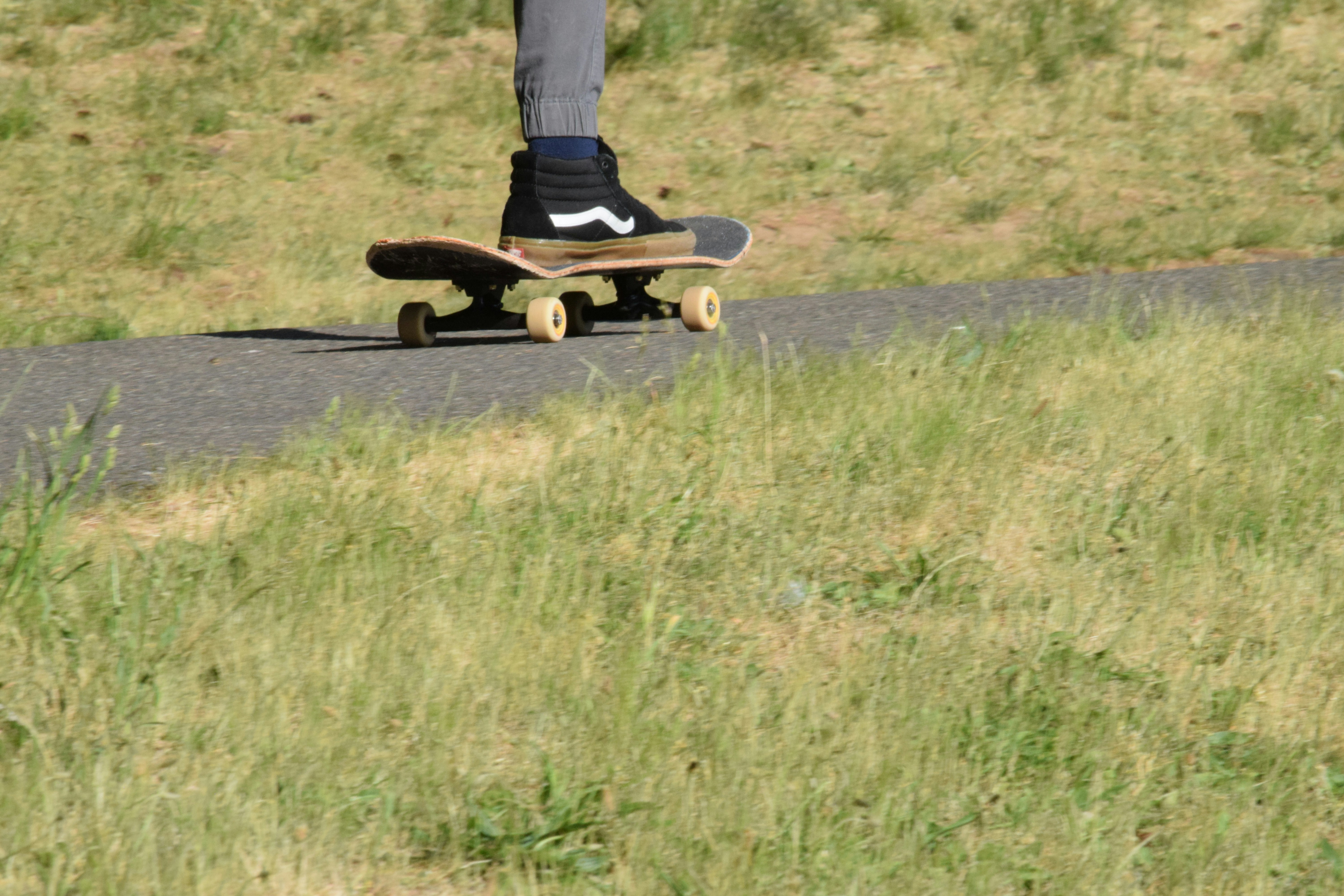 a person riding a skateboard down a road