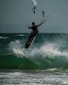 a man riding a surfboard on top of a wave