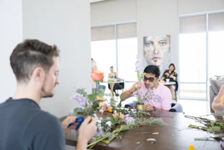 A group of people sitting around a wooden table
