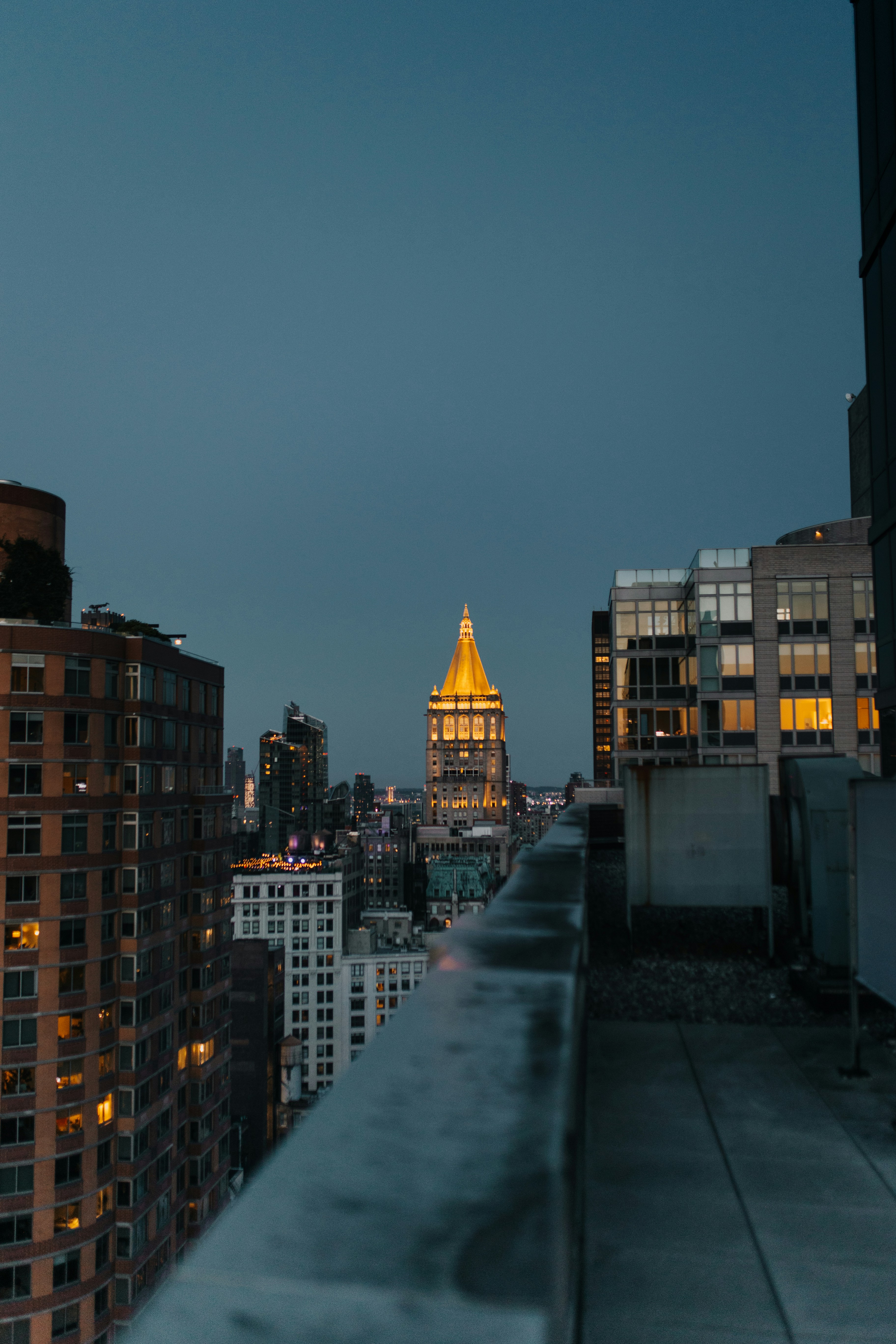 A view of a city at night from a rooftop photo – Free City Image on ...