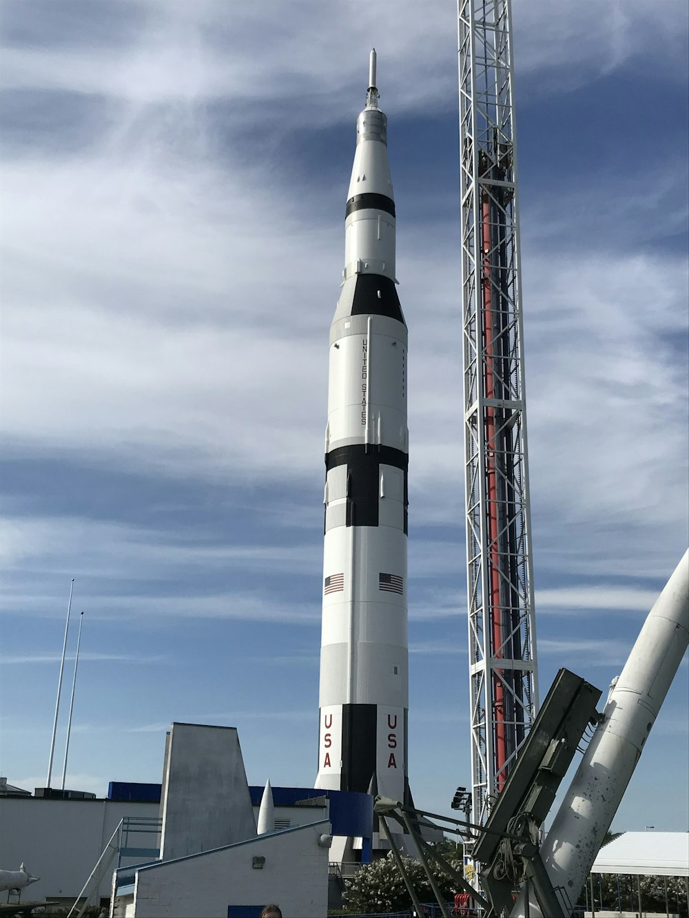 a man standing in front of a rocket on display