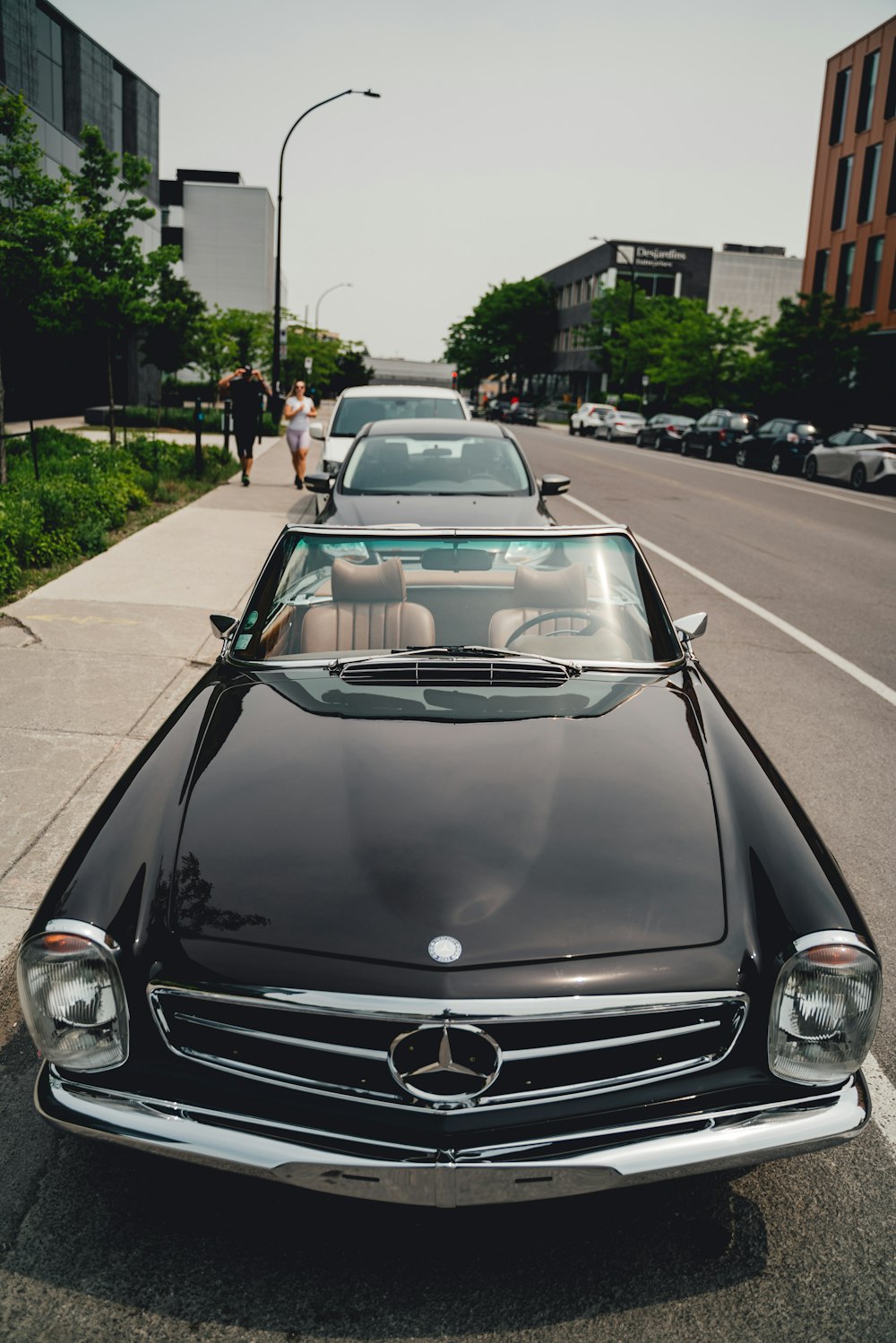 a row of cars parked on the side of a road