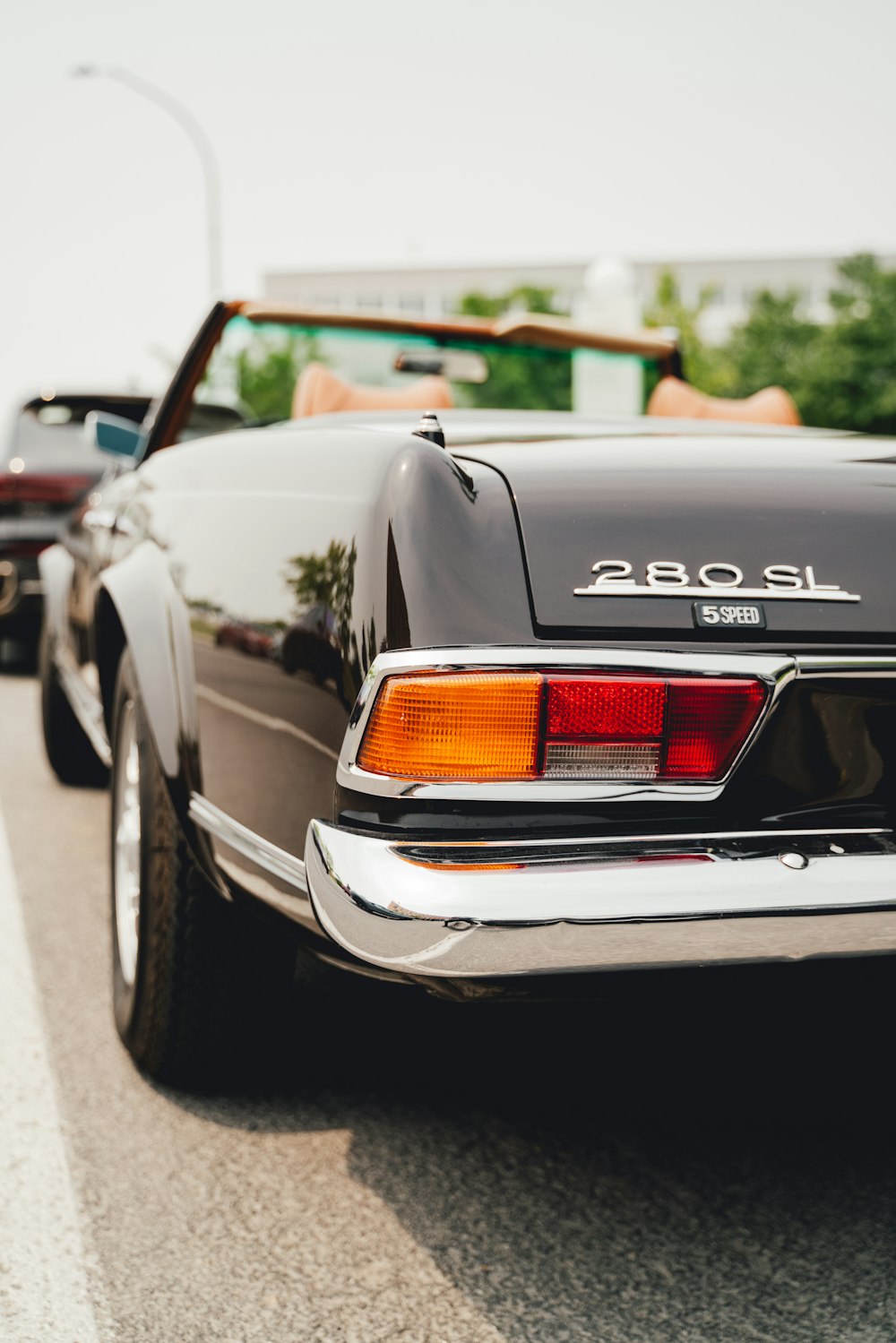 a black car parked on the side of the road