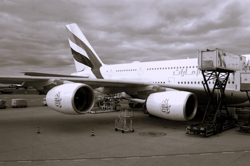 A large airport media billboard featuring colorful branding, visible to travelers and planes.