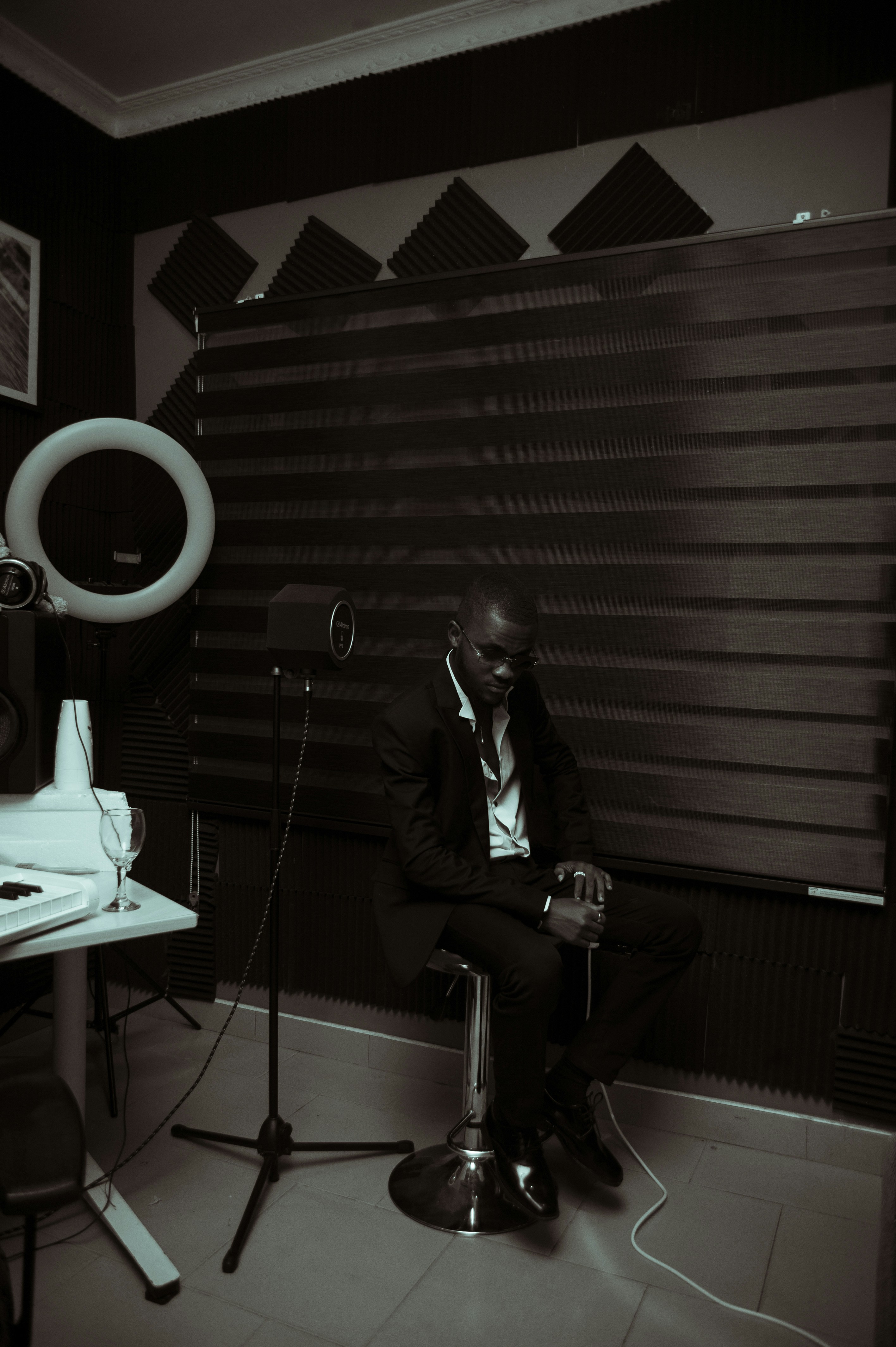 a man sitting in a chair in front of a microphone