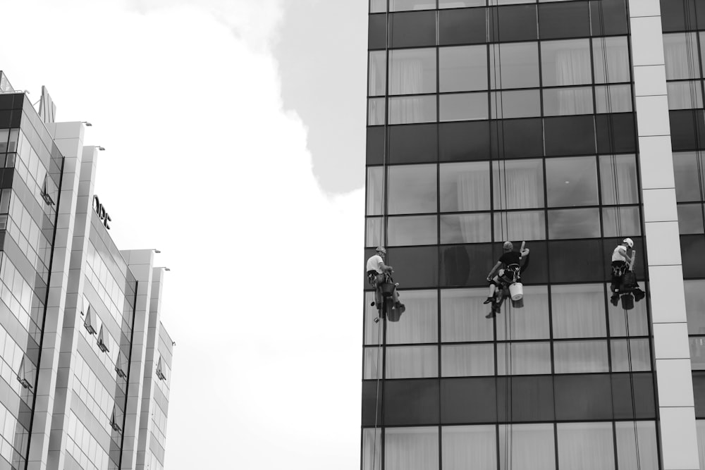 a black and white photo of a man on a window washer