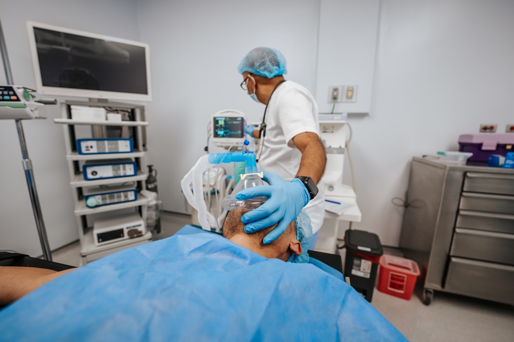 a man in a hospital room getting his teeth checked