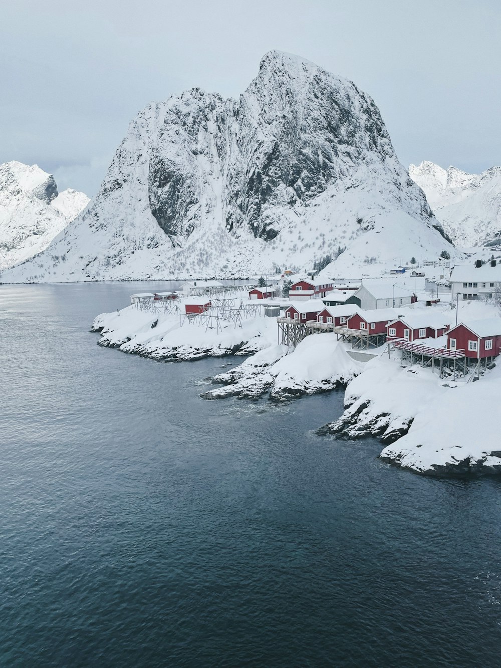 a snowy landscape with a mountain in the background