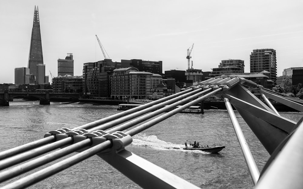 a black and white photo of a boat on a river