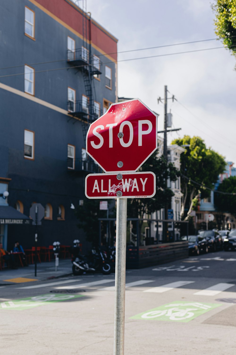 a red stop sign sitting on the side of a road