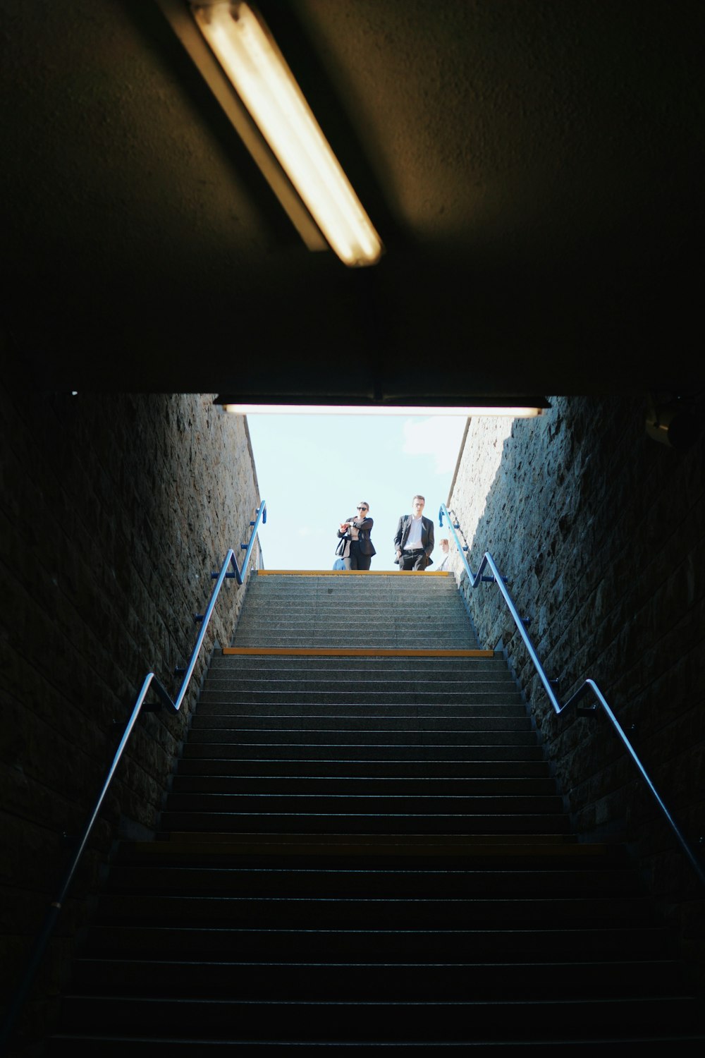 two people sitting on a set of stairs