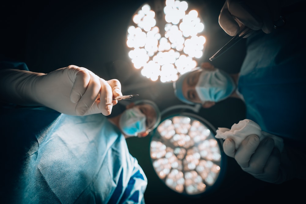 a person in a surgical mask holding a lit candle