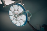 a person operating a medical light in a room