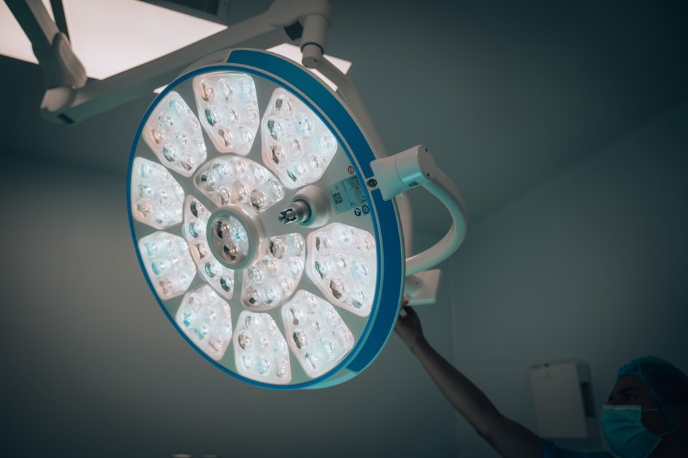 a person operating a medical light in a room