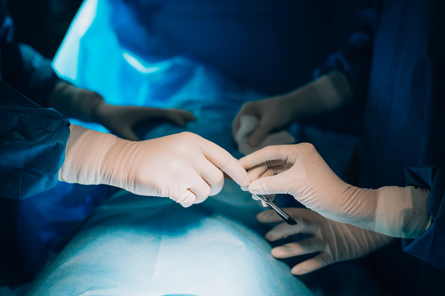 Close-up of hands performing a surgical procedure