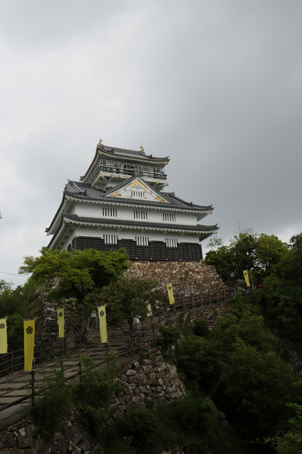 a tall white building sitting on top of a hill