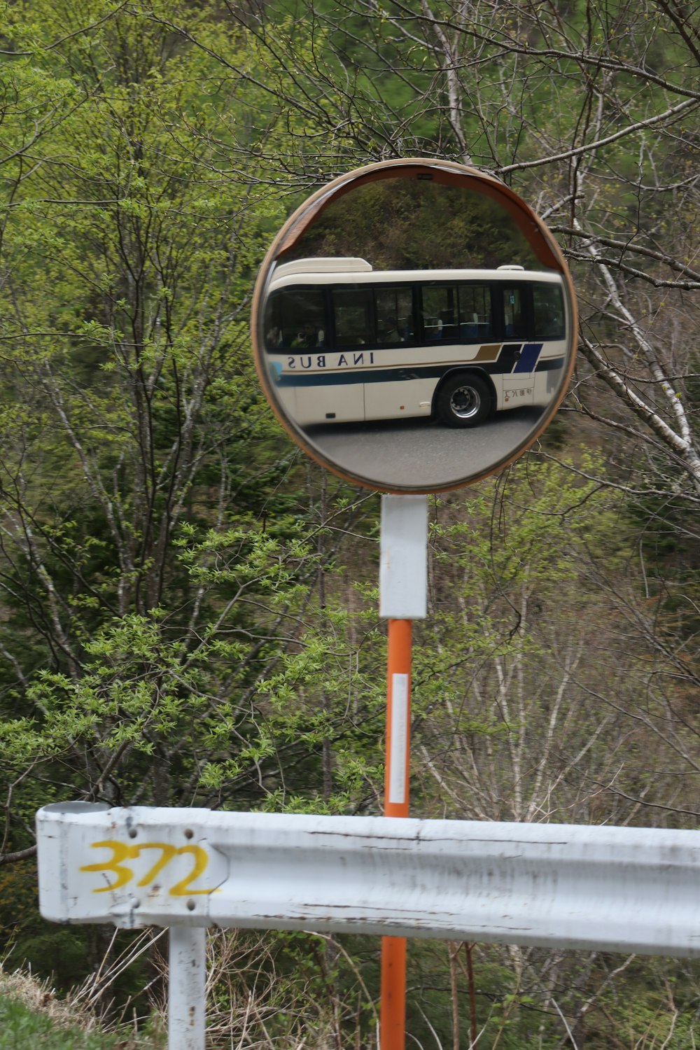 a bus is reflected in a round mirror