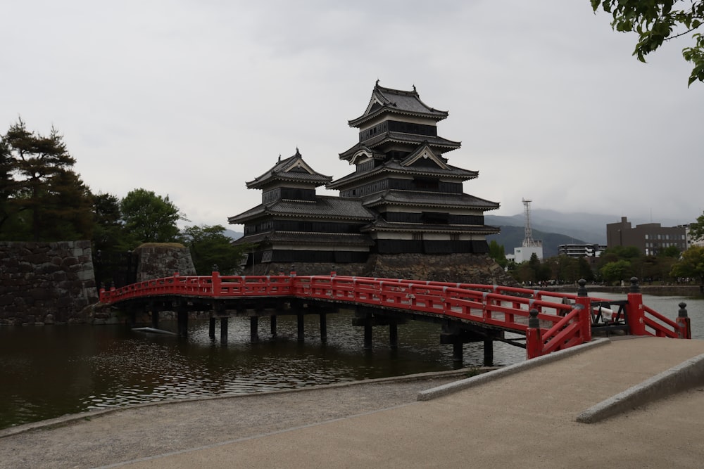 a red bridge over a body of water