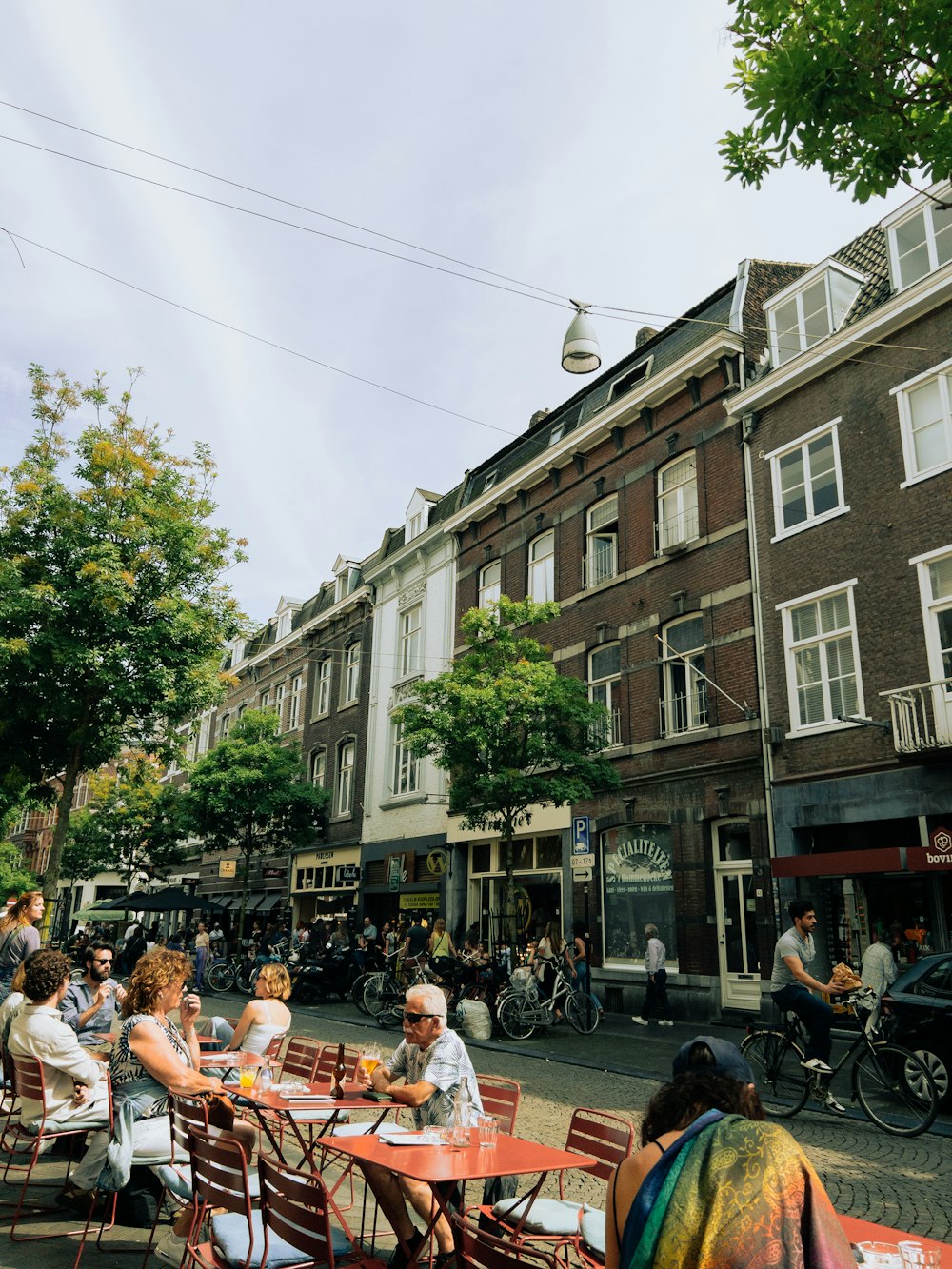 a group of people sitting at a table in front of a building