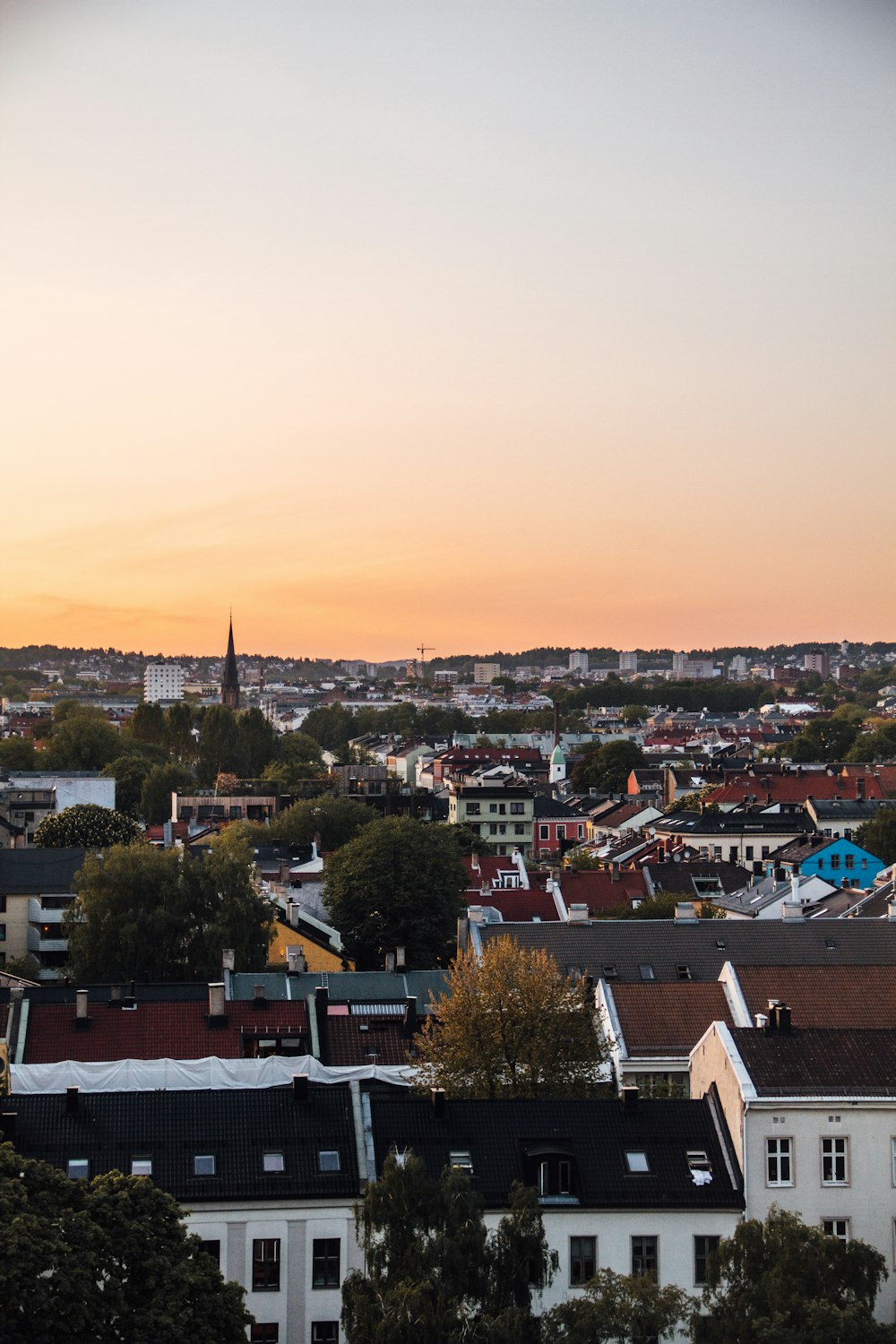 a view of a city at sunset from a hill