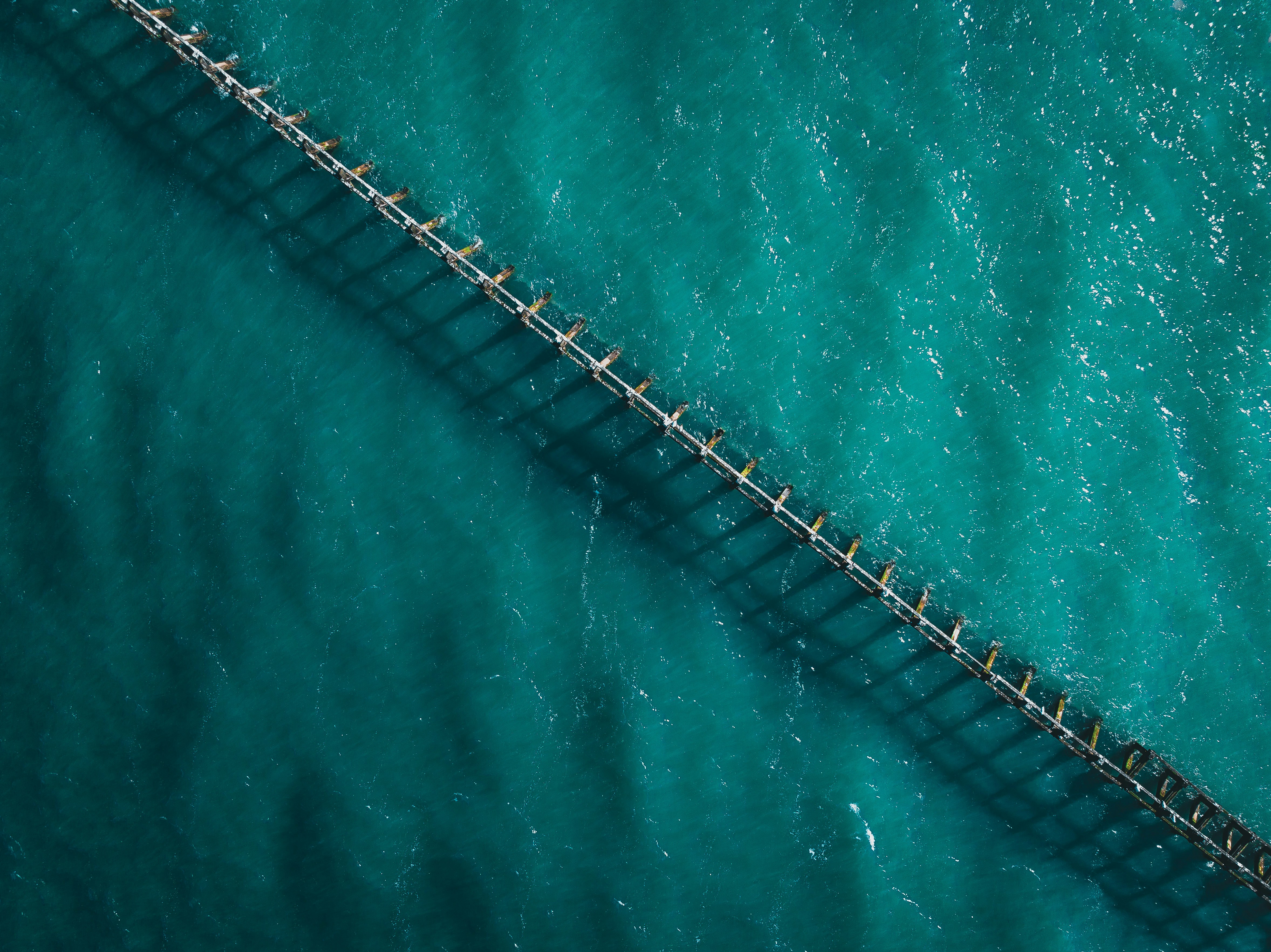 an aerial view of a bridge over a body of water