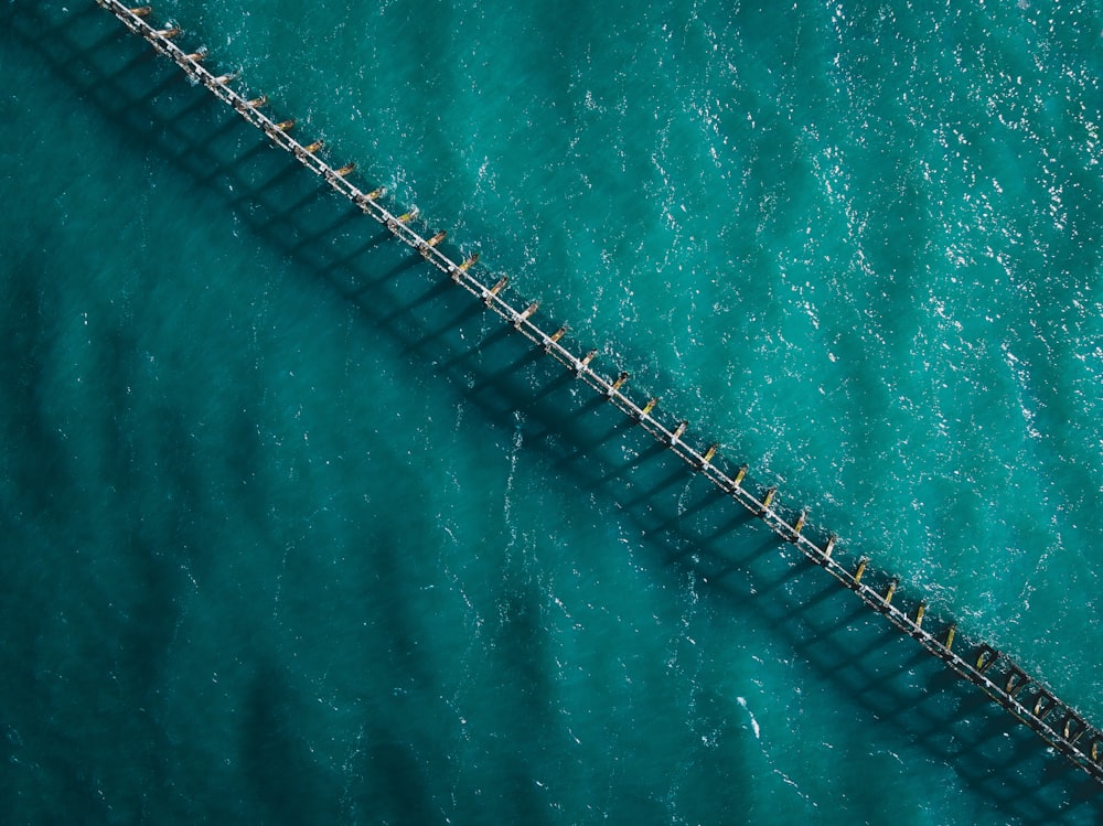 an aerial view of a bridge over a body of water