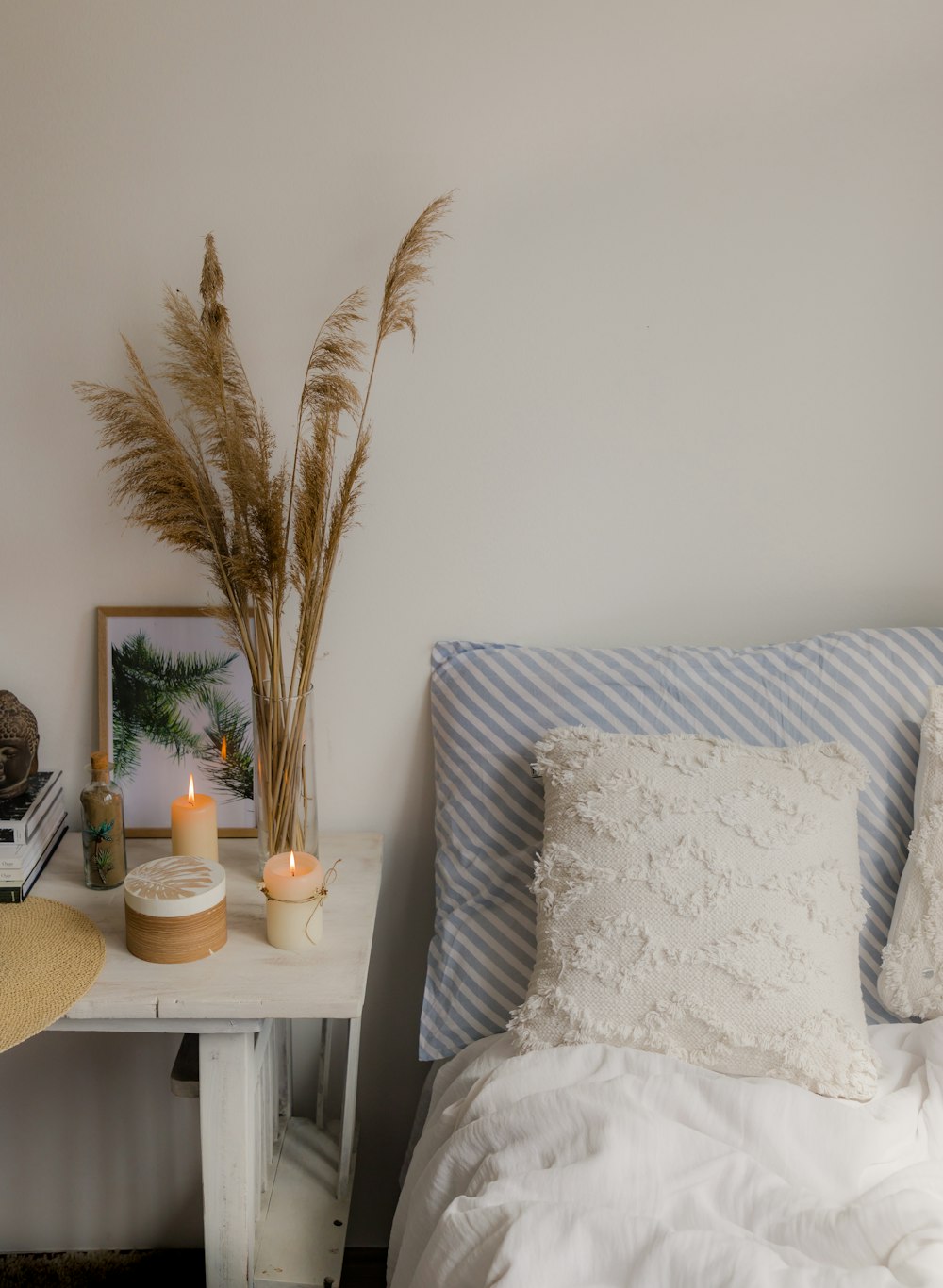 a bed with a white comforter and pillows