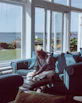 An engaging photo of a person reading Sovereign Insight articles on a tablet in a cozy home office.