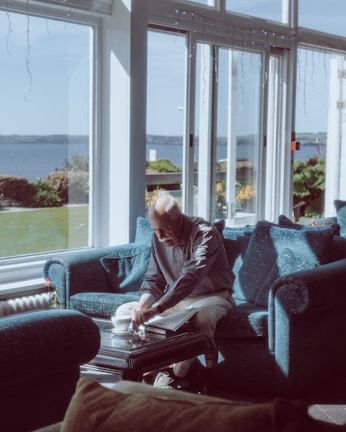 A serene behind-the-scenes moment showing the actor reviewing script notes in a cozy, sunlit room.