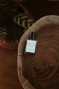 An elegant image of a minimalist perfume bottle surrounded by soft textures.