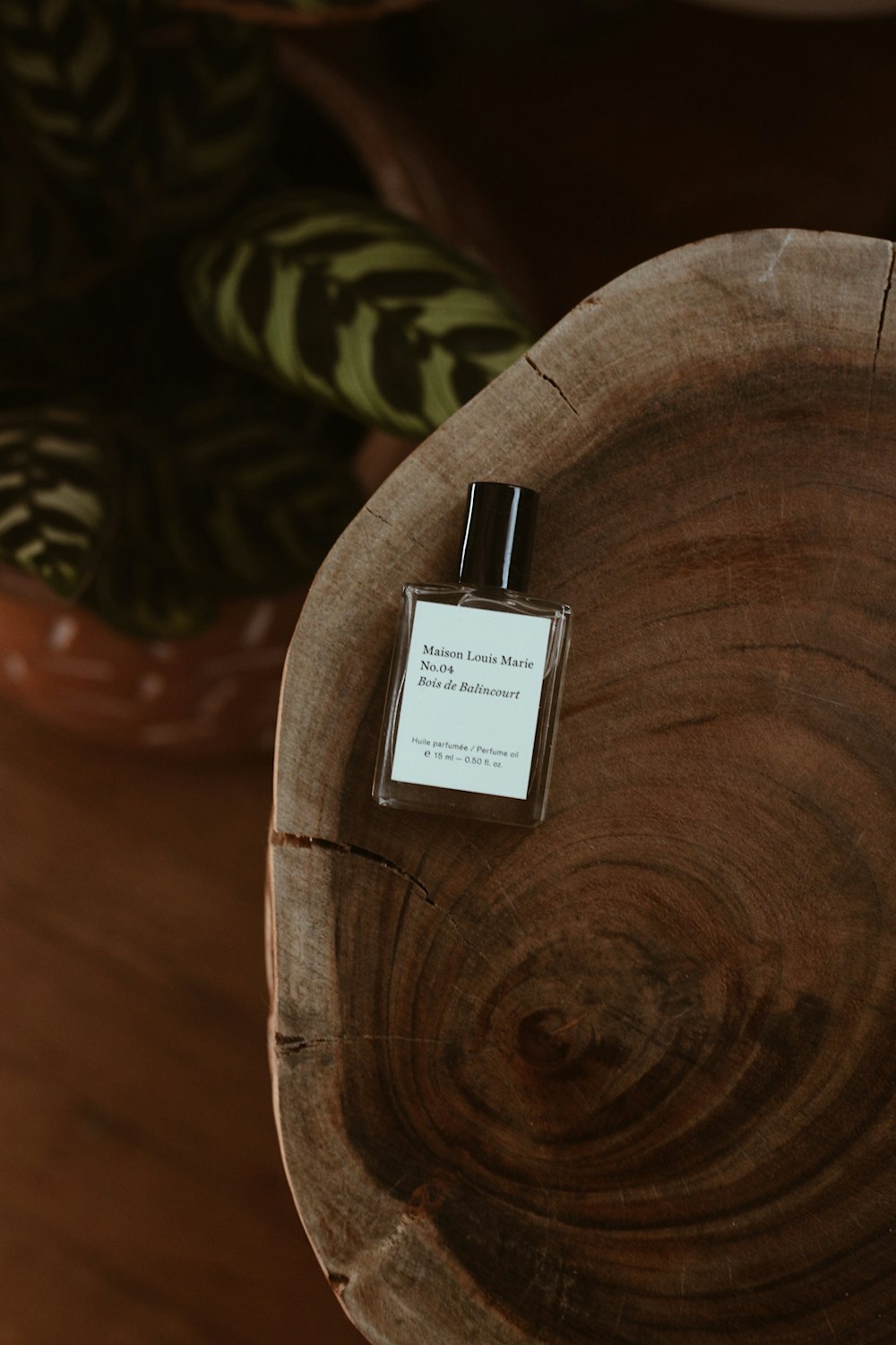 a bottle of perfume sitting on top of a wooden table