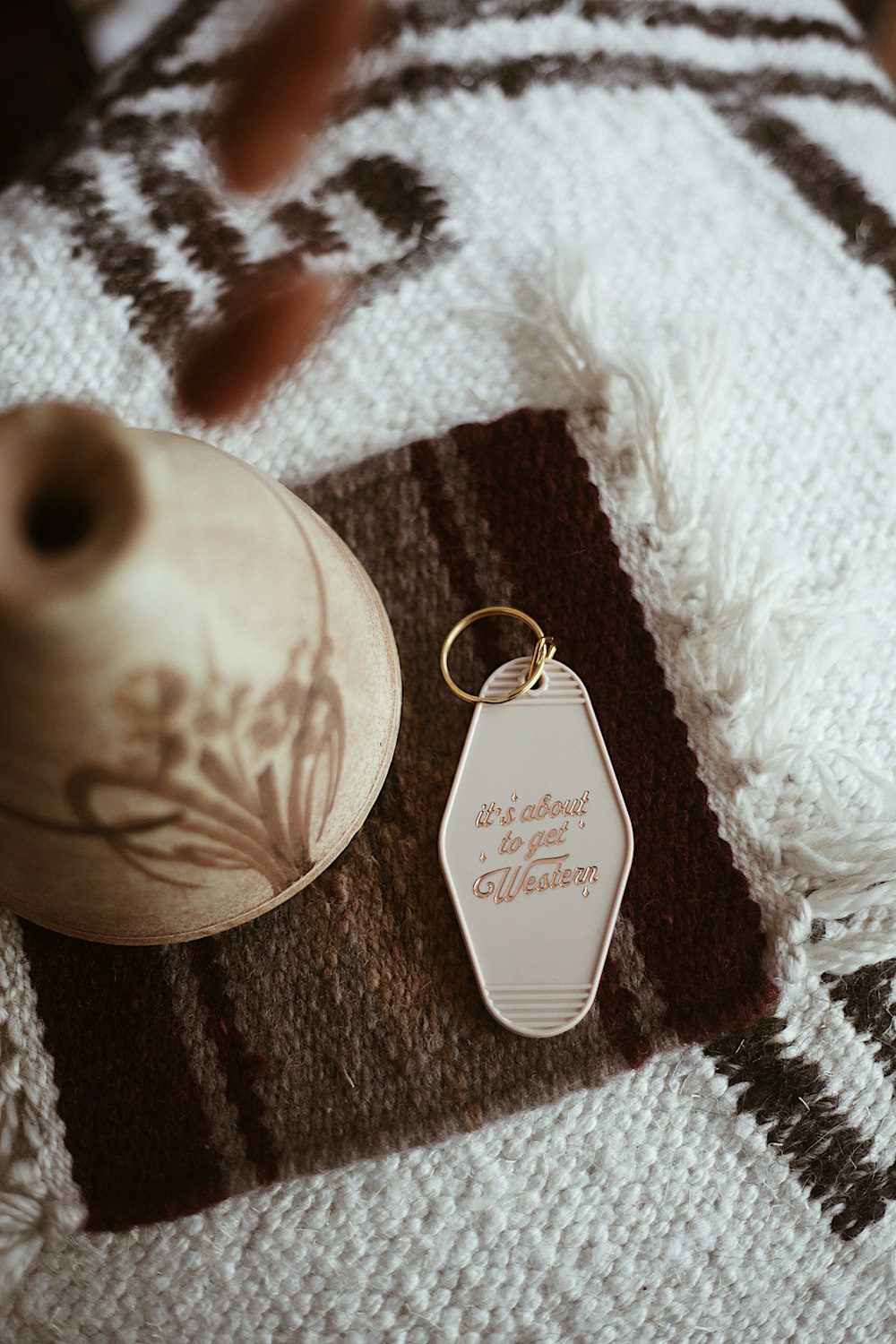 a close up of a key chain on a blanket