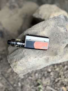 A compact vape mod with a digital display and ergonomic grip.