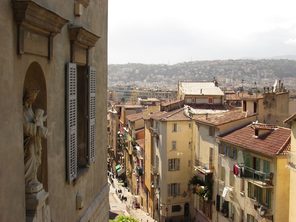 a view of a city with buildings and a statue