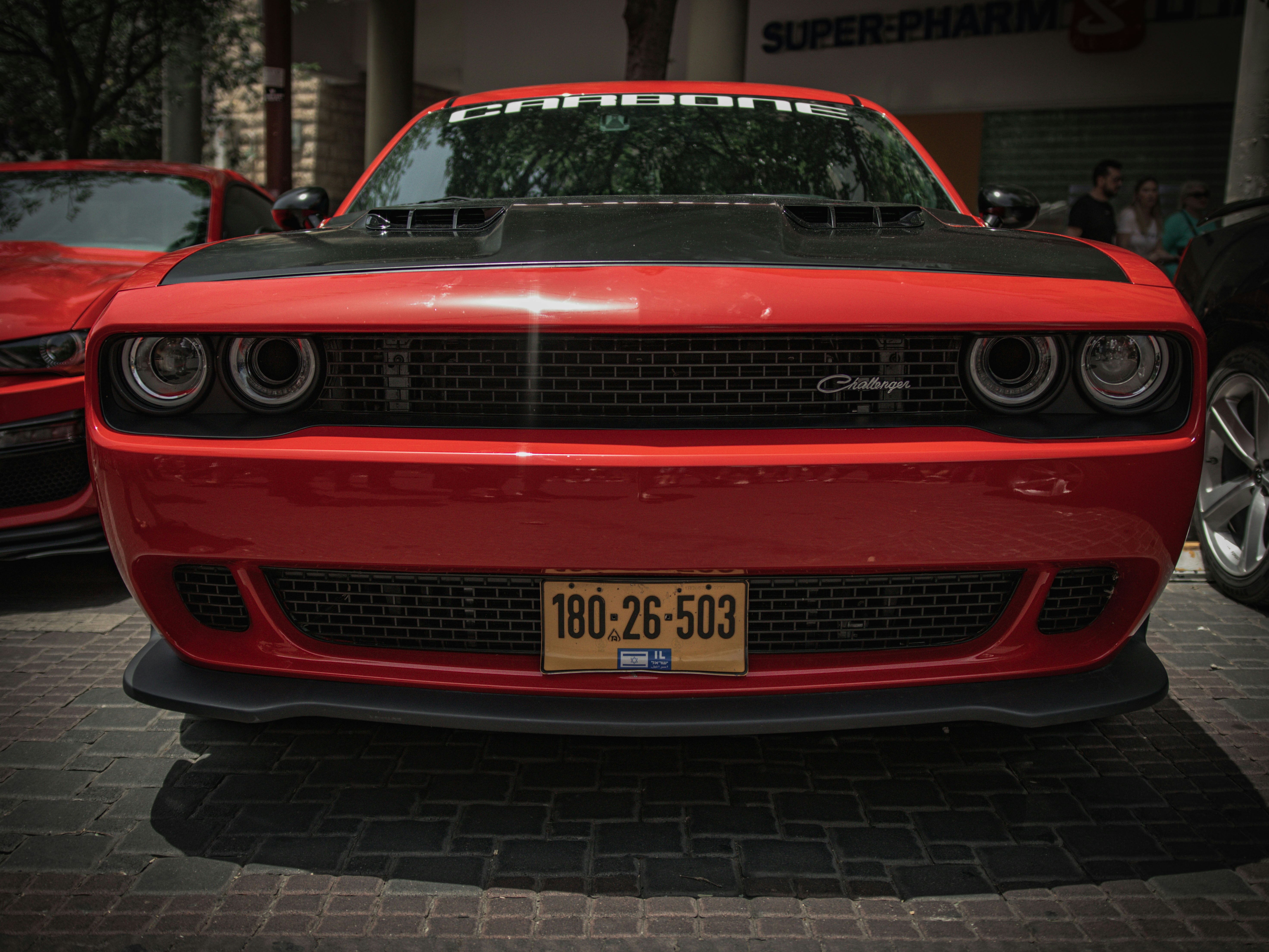 a red sports car parked in front of a building