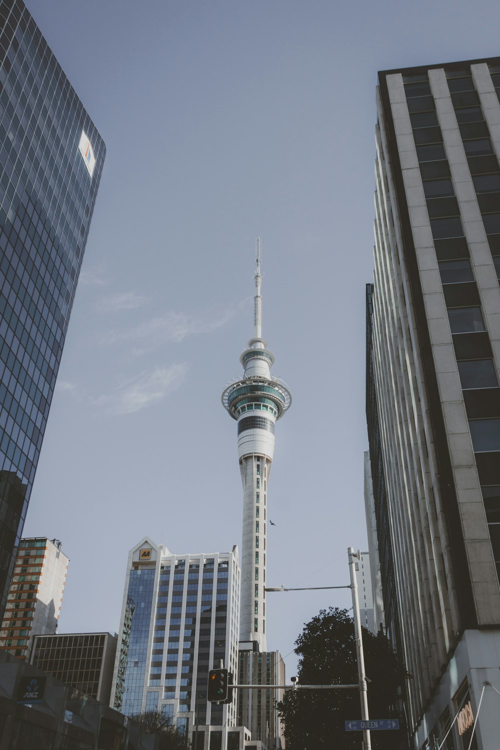 a very tall tower towering over a city filled with tall buildings