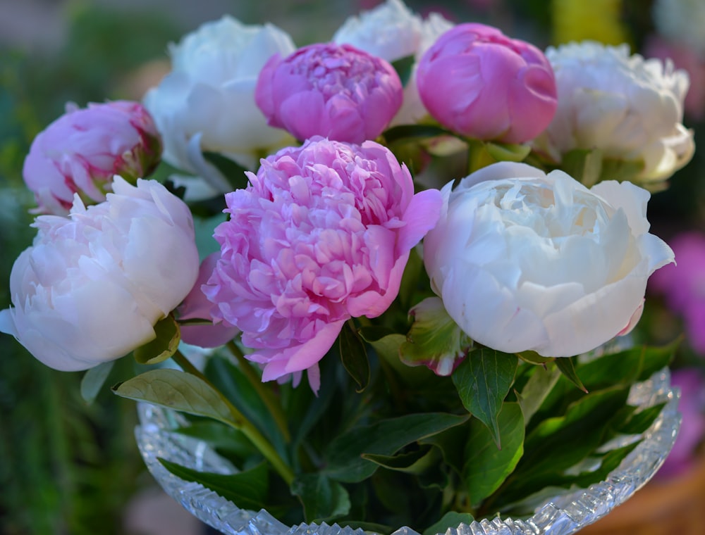 a bunch of pink and white flowers in a vase