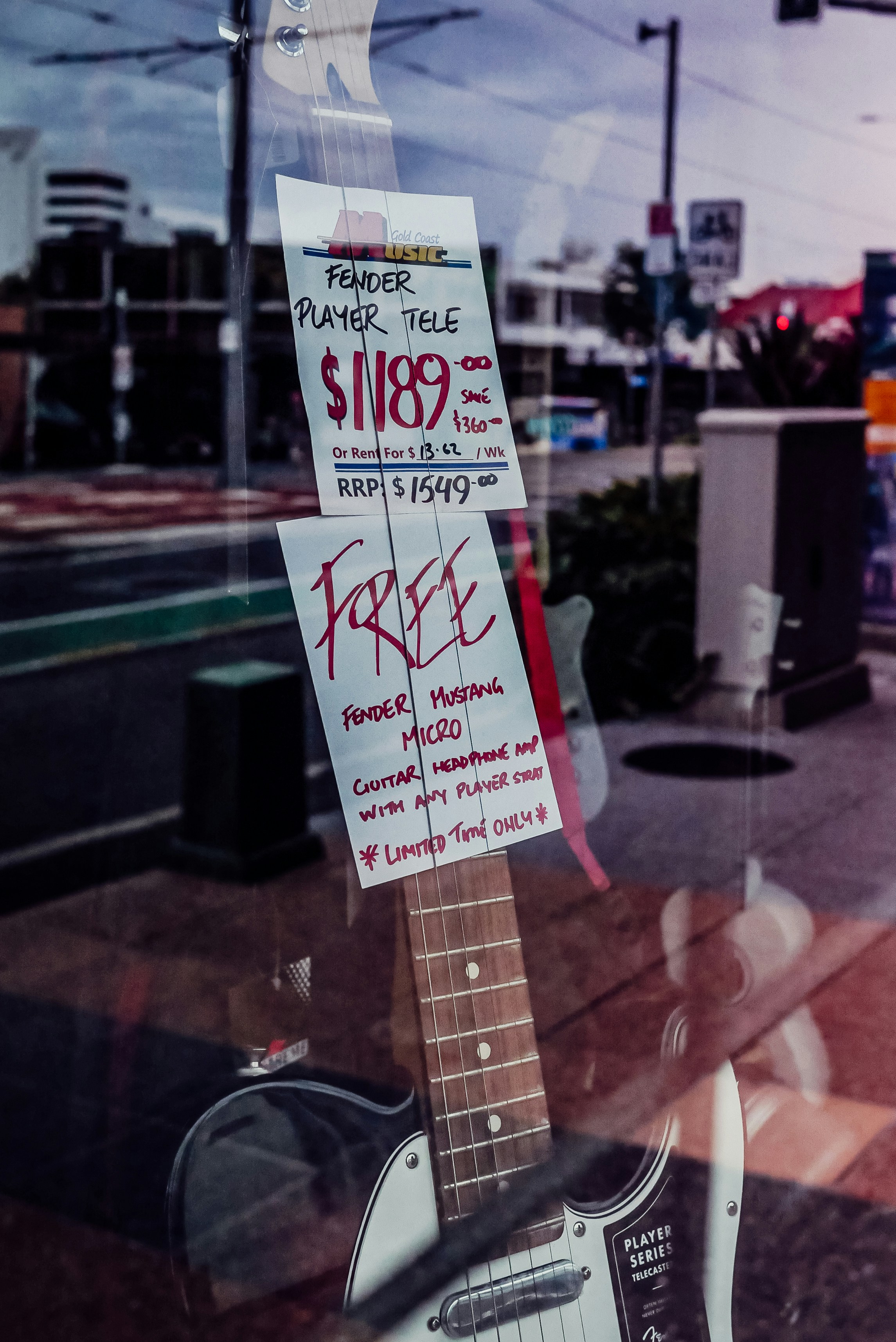 a guitar is for sale in a store window