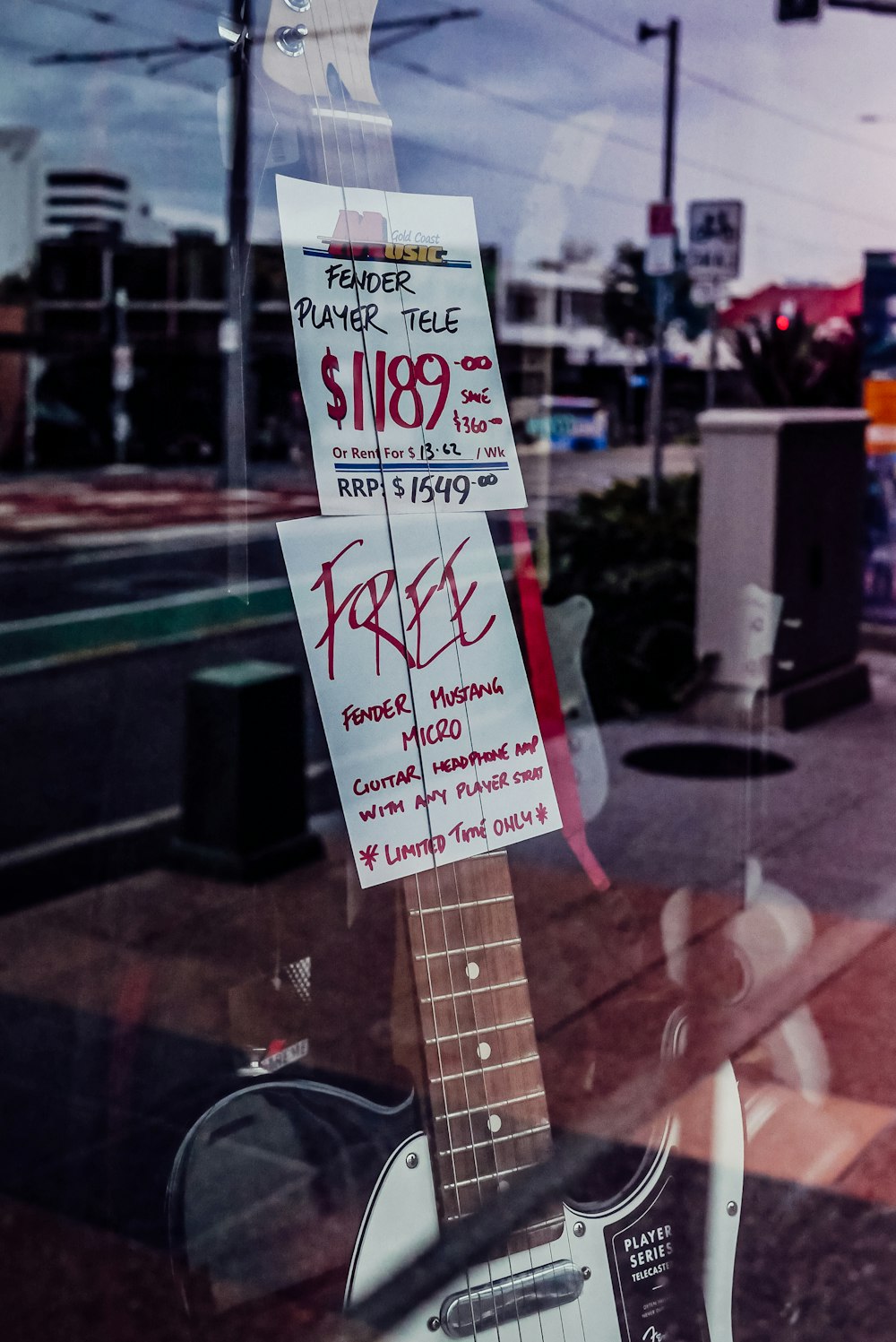 a guitar is for sale in a store window