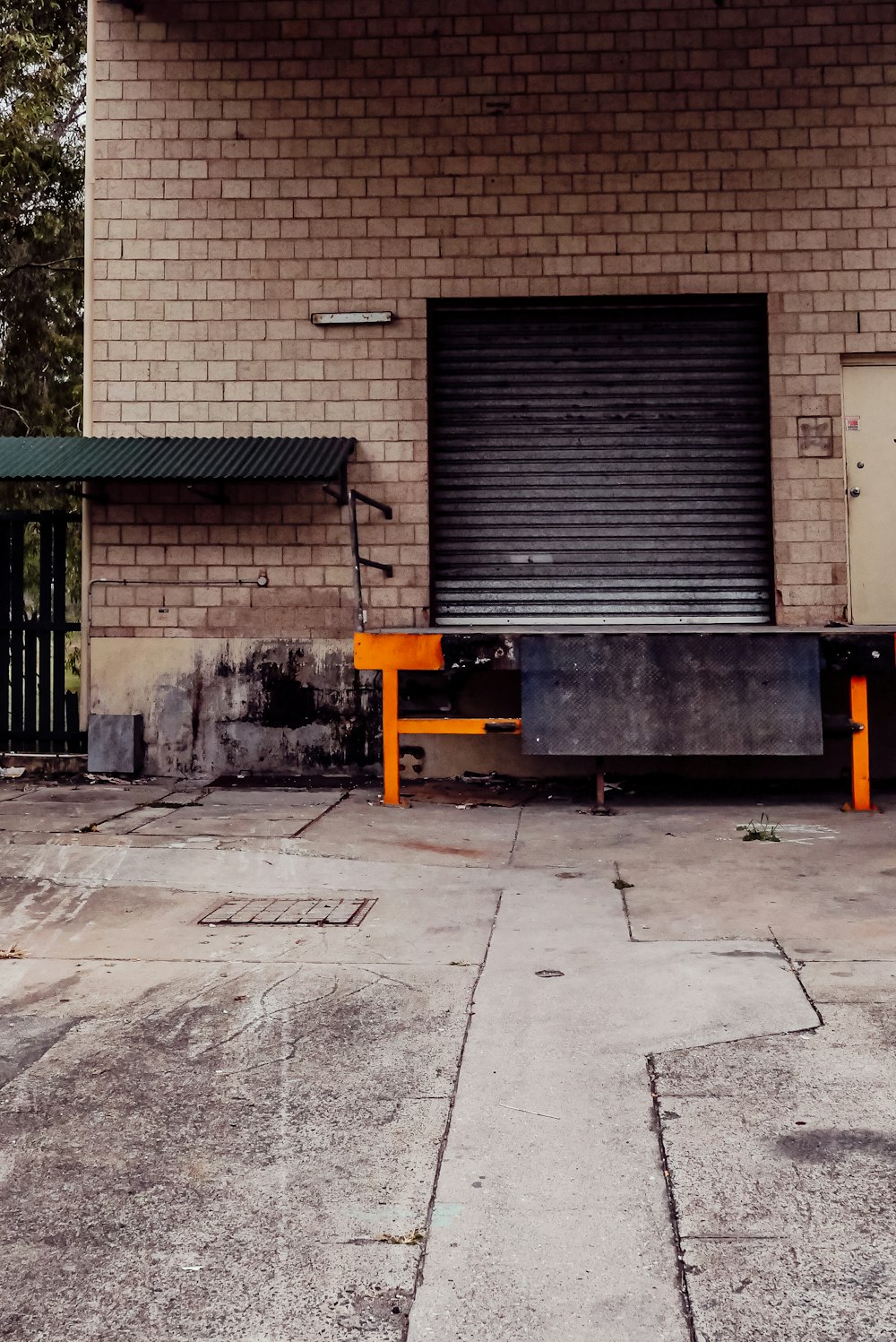 an orange bench sitting in front of a brick building