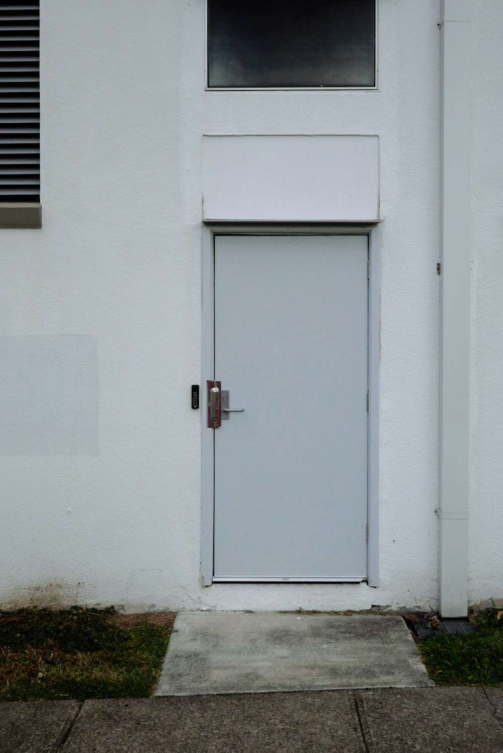 a white building with a white door and window