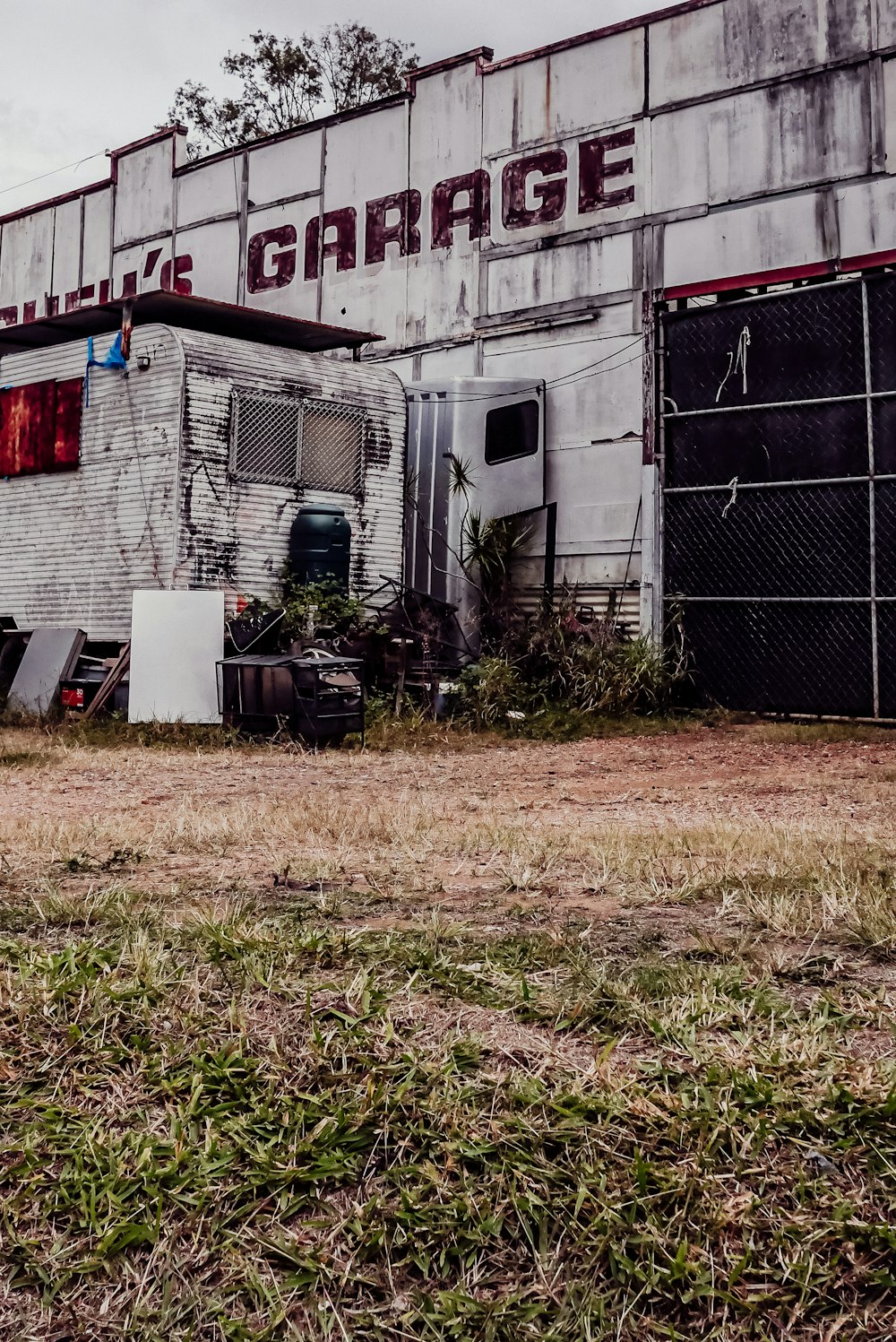 an old building with a sign that says garage next to it