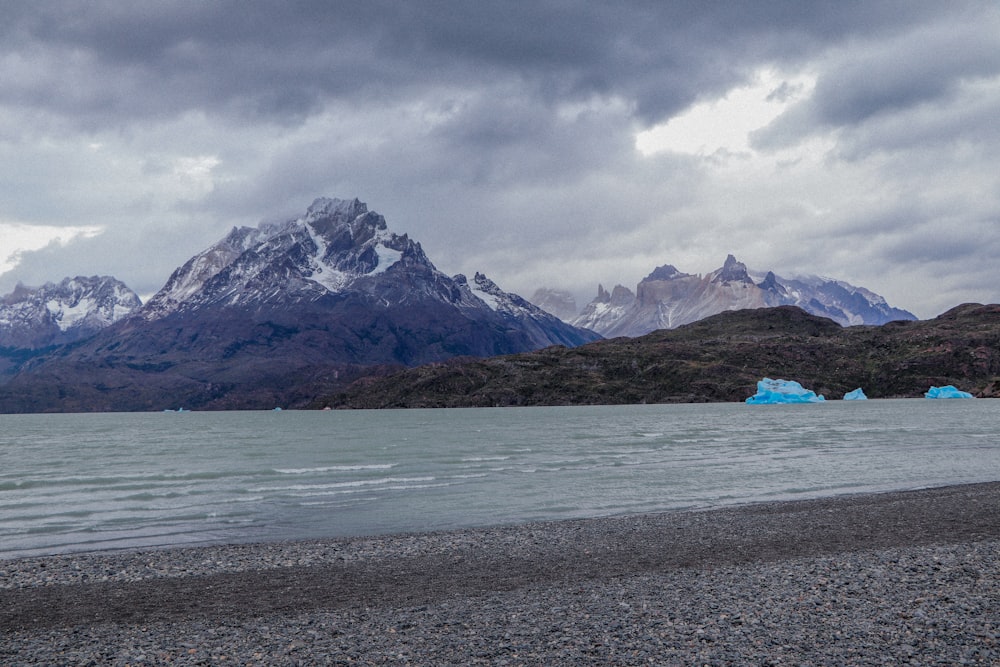 a body of water with mountains in the background